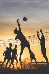 silhouette of people playing basketball during sunset