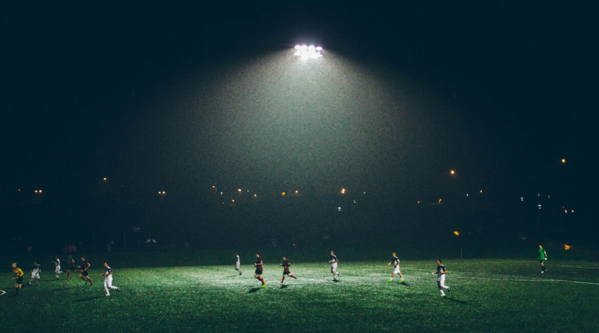 group of people playing soccer on soccer field