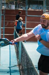 a man holding a tennis racquet on top of a tennis court