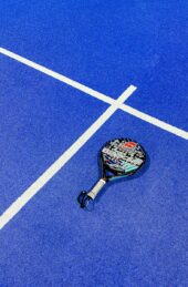 a tennis racket on a blue tennis court