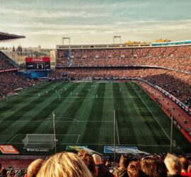 green soccer field with crowd at daytime
